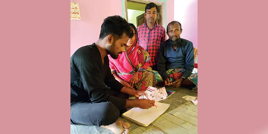 Nazrul Molla helping clients fill up forms to get registered in the NRC (Photo credit : Nazrul Molla)