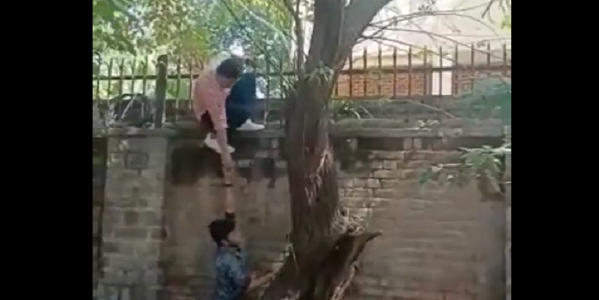 Men seen climbing over Miranda House walls. (Source: Twitter account of student)