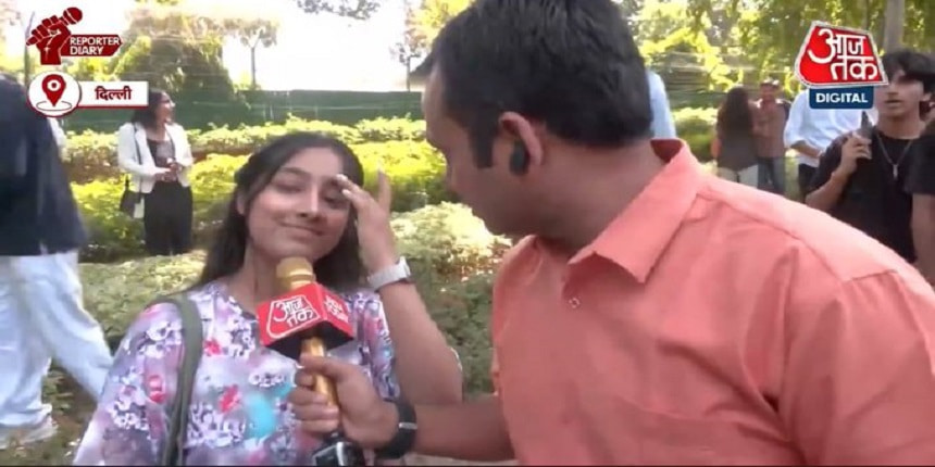 A reporter interacting with the protesting students. (Image: Screen grab from the video shared by Aaj Tak)