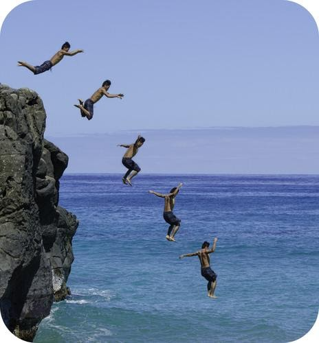 A group of people jumping into the water free fall