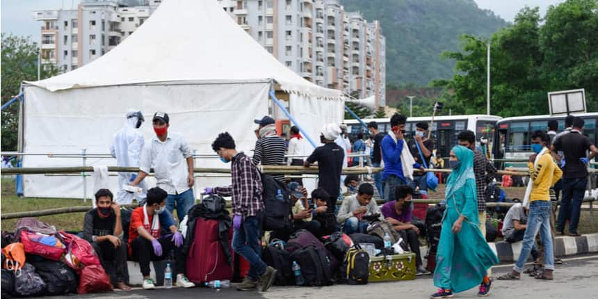 People from various states wait for their screening after arriving at a quarantine centre to spend mandatory 14 days of quarantine, in Guwahati. (Source: Shutterstock)