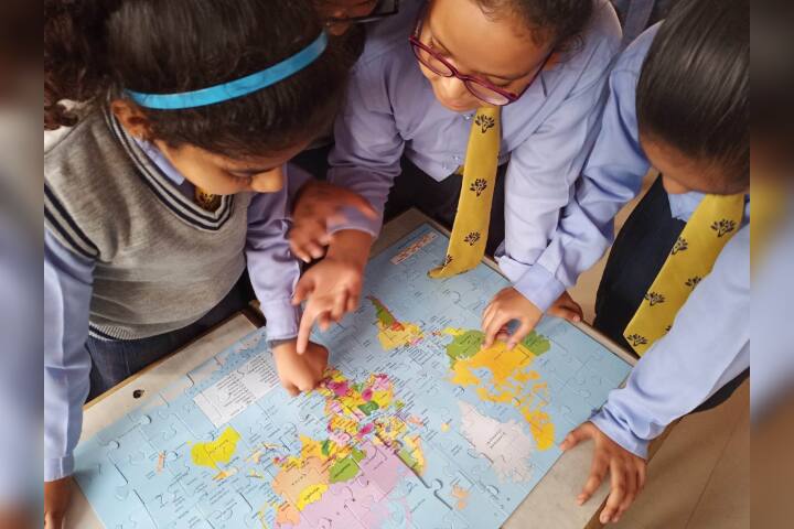 The Modern School- Student Studying Map