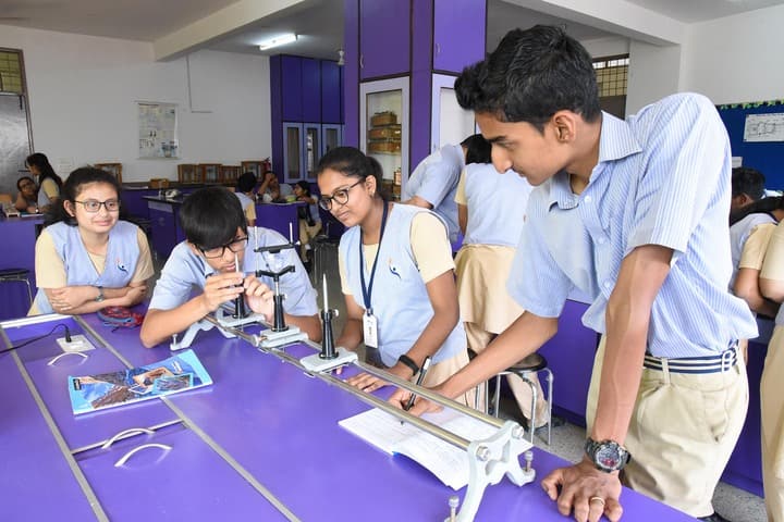 Indian students performing physics experiment in school laboratory